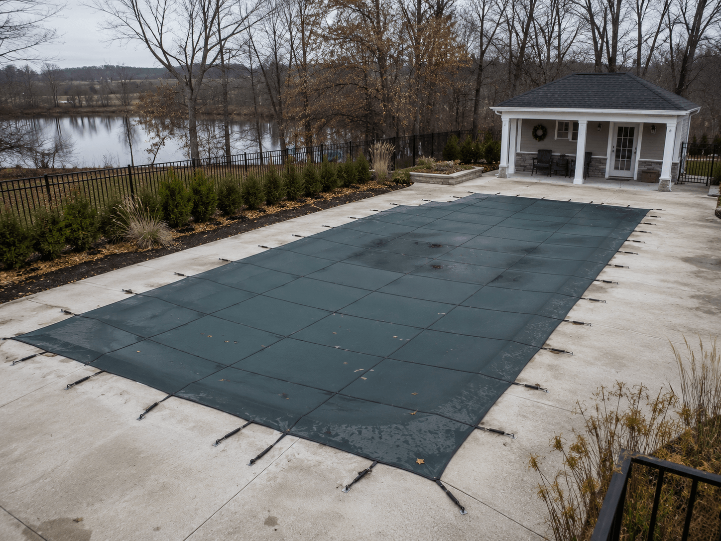 Pool closing mesh safety cover fiberglass pool Guelph Ontario Fiberglass pool with mesh safety cover installed for winter Guelph Ontario