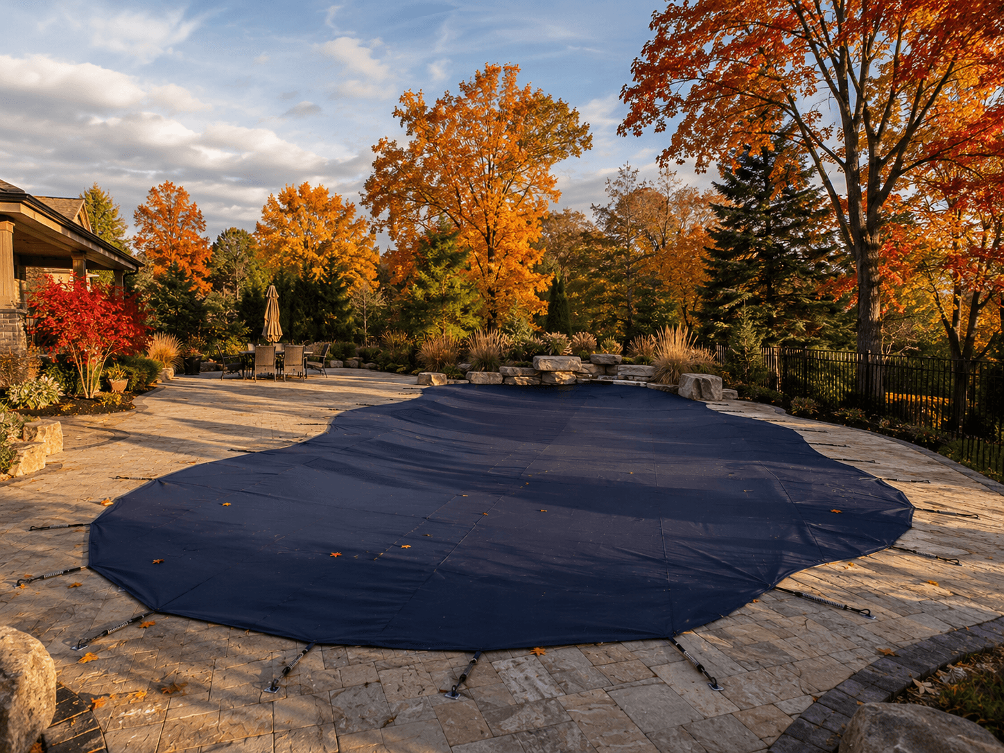 Pool closing safety cover freeform pool fall Wellington County Freeform inground pool with safety cover installed for winter Wellington County Ontario